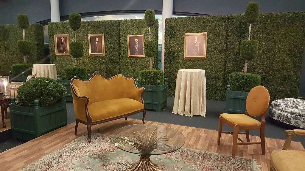 Boxwood hedge wall rental with topiary accents